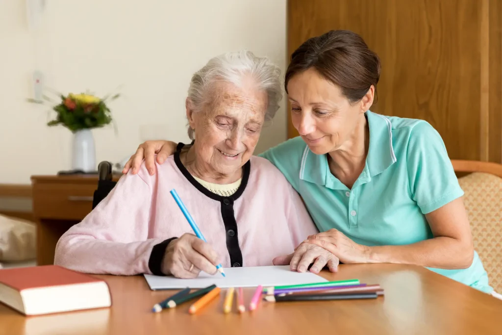 Caregiver and senior woman coloring
