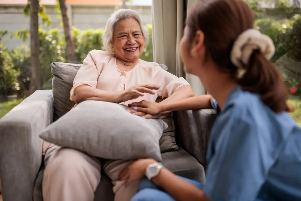 Female caregiver provides emotional support to an elderly woman