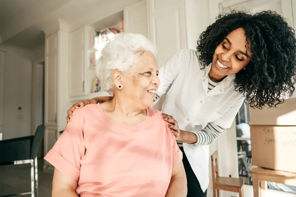Senior women with caregiver smiling